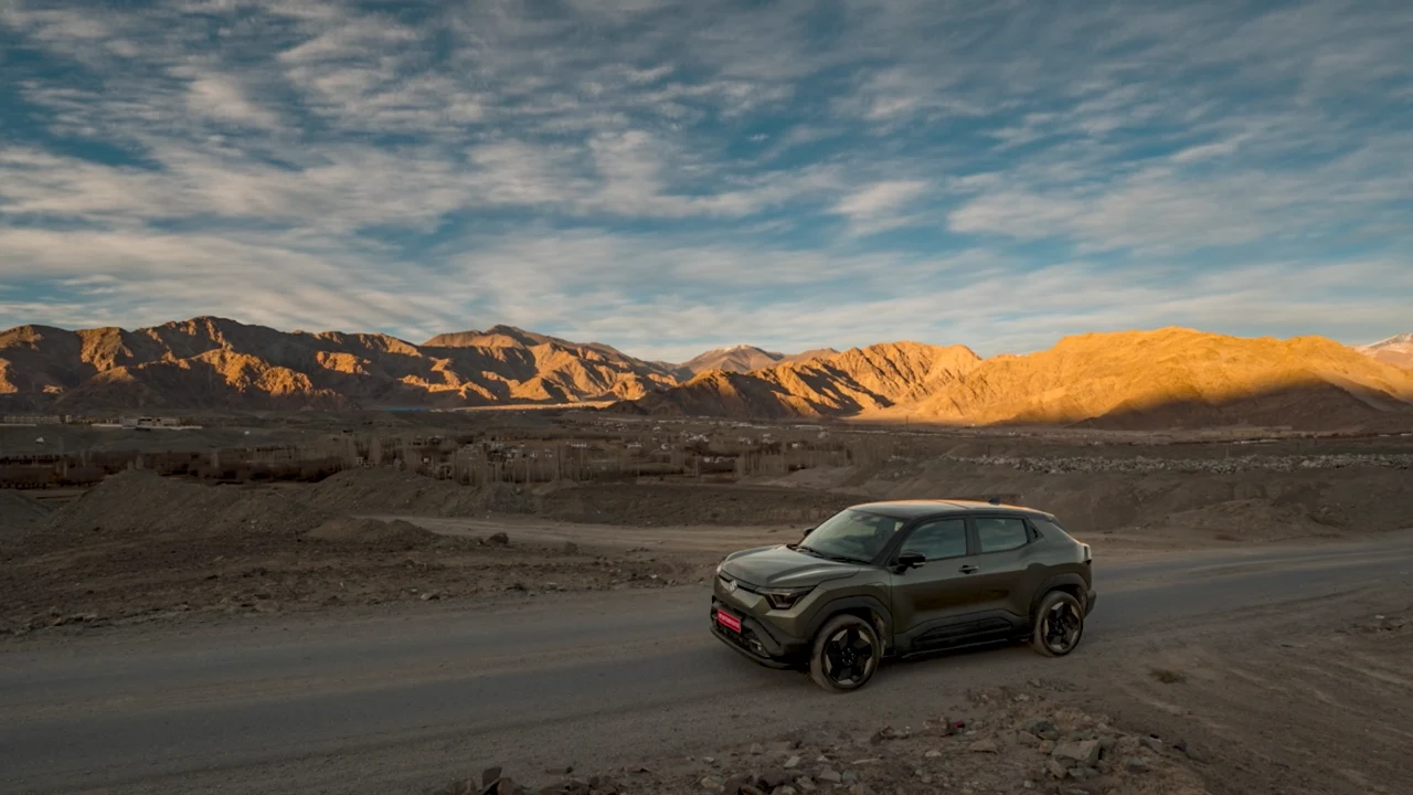 A car set against a dramatic mountain landscape